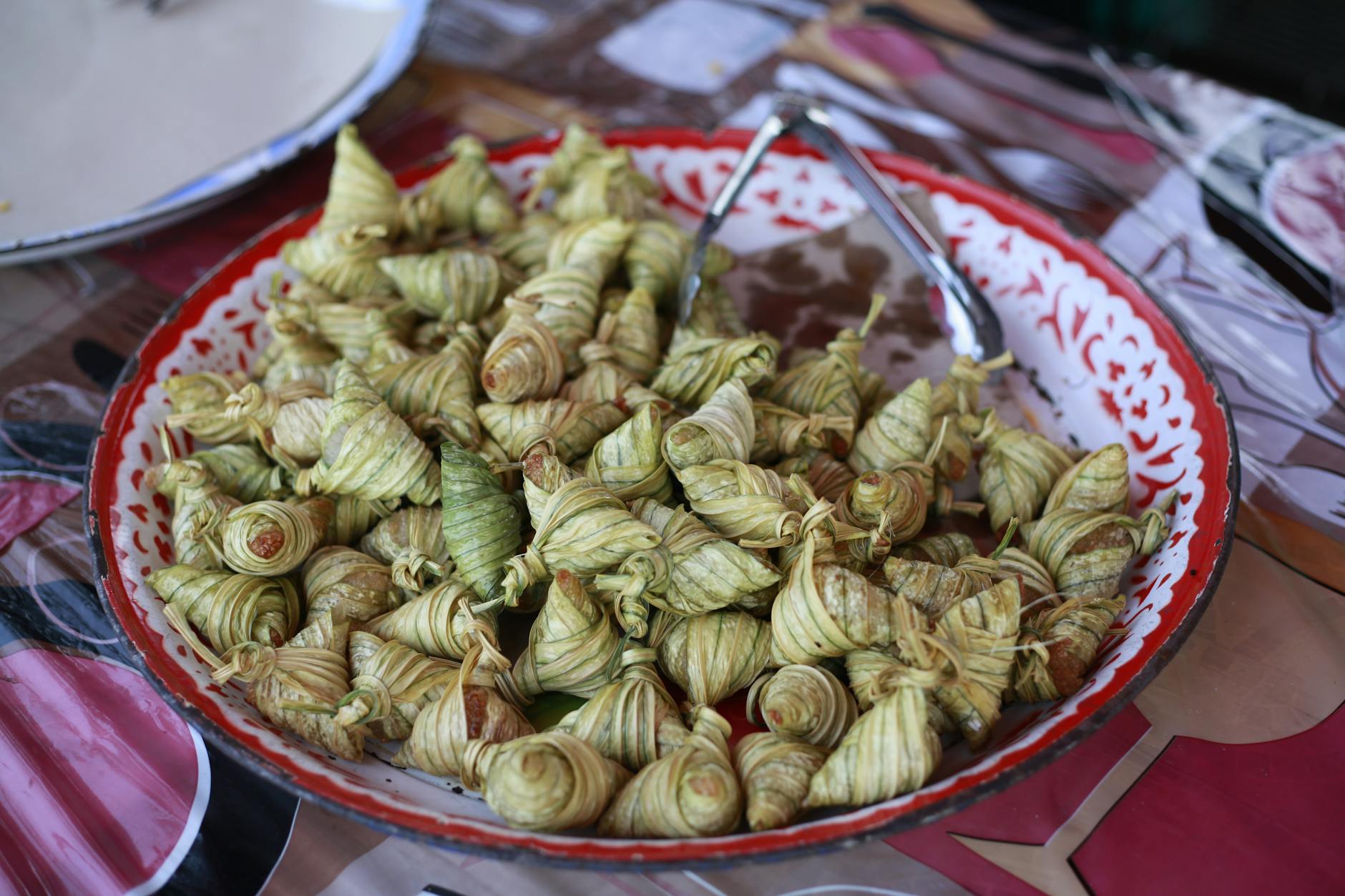 close up of a bowl full of ketupat